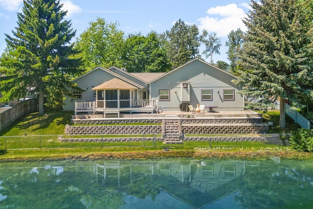 238 Red Fox Rd, Lolo, MT 59847 - rear view of house with a sunroom and a water view