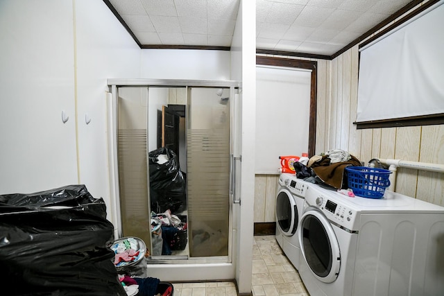 712 9th St N, Great Falls, MT 59401 - laundry area featuring independent washer and dryer, cabinet space, and wooden walls