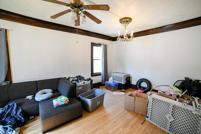 712 9th St N, Great Falls, MT 59401 - living room featuring ornamental molding, wood finished floors, a ceiling fan, a chandelier, and baseboards