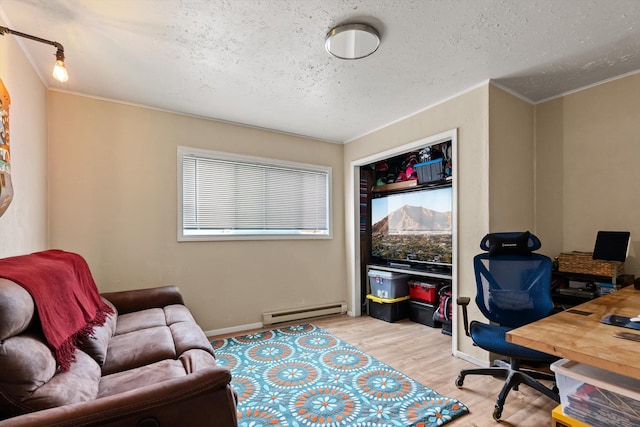 1108 4th Ave W, Columbia Falls, MT 59912 - office area with a baseboard heating unit, a textured ceiling, wood finished floors, ornamental molding, and baseboards