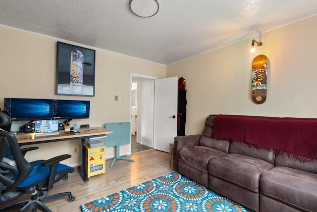1108 4th Ave W, Columbia Falls, MT 59912 - office area featuring wood finished floors, built in desk, crown molding, and a textured ceiling
