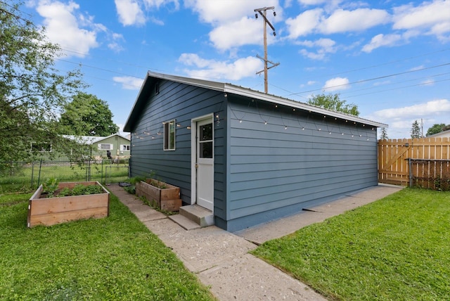 1108 4th Ave W, Columbia Falls, MT 59912 - view of outbuilding featuring a garden and a gate