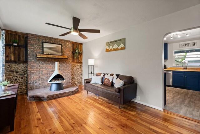 1108 4th Ave W, Columbia Falls, MT 59912 - living area featuring light wood-style floors, a ceiling fan, and arched walkways