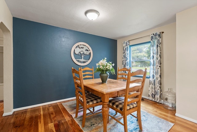 1108 4th Ave W, Columbia Falls, MT 59912 - dining area with wood finished floors, arched walkways, and baseboards