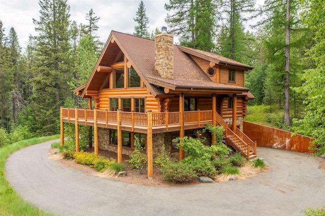599 Talon Trl, Columbia Falls, MT 59912 - log-style house with log exterior, a chimney, stone siding, and roof with shingles