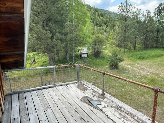 63450 US Highway 2, Libby, MT 59923 - wooden terrace featuring a lawn and a wooded view