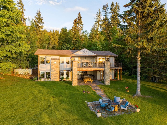 34777 Compass Ln, Polson, MT 59860 - rear view of house featuring a patio, a wooden deck, a yard, and a wooded view