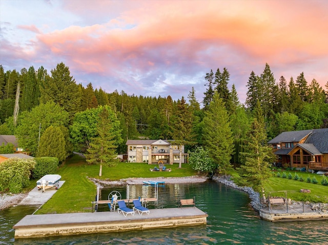 34777 Compass Ln, Polson, MT 59860 - dock area featuring a water view, a view of trees, and a yard