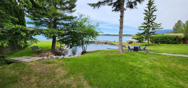 34777 Compass Ln, Polson, MT 59860 - view of grassy yard featuring a water view and a dock