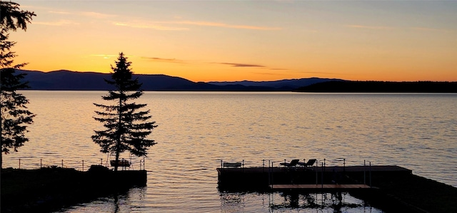 34777 Compass Ln, Polson, MT 59860 - water view featuring a floating dock and a mountain backdrop