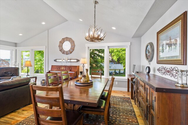 34777 Compass Ln, Polson, MT 59860 - dining space featuring lofted ceiling, light wood-style flooring, healthy amount of natural light, a chandelier, and recessed lighting