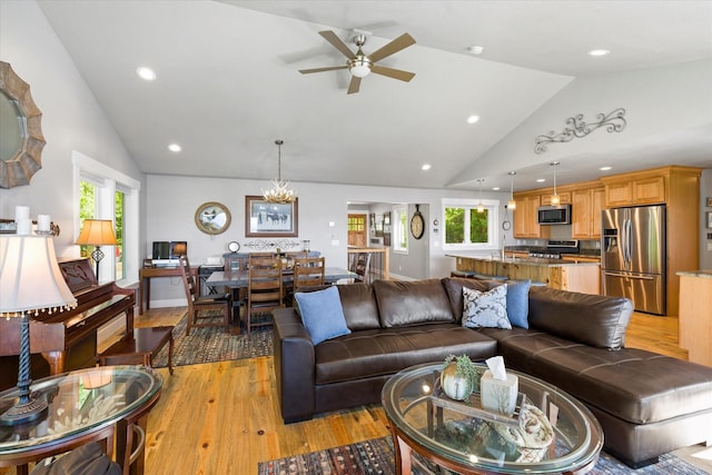 34777 Compass Ln, Polson, MT 59860 - living room with light wood-type flooring, ceiling fan, plenty of natural light, high vaulted ceiling, and recessed lighting