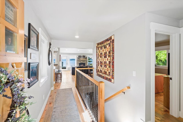 34777 Compass Ln, Polson, MT 59860 - hall with light wood-type flooring, an upstairs landing, healthy amount of natural light, recessed lighting, and baseboards