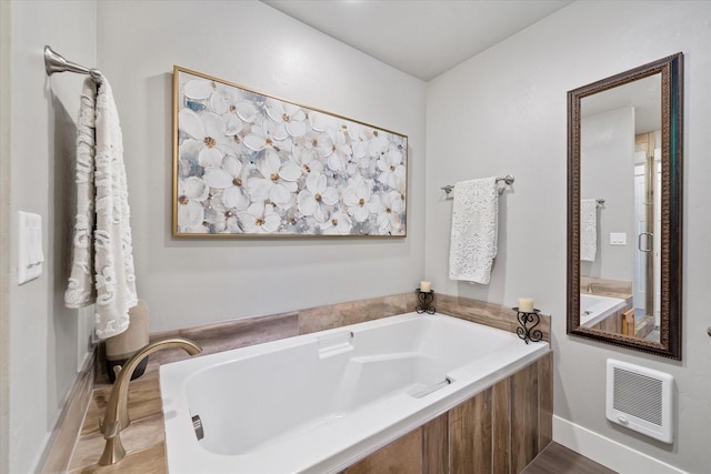 34777 Compass Ln, Polson, MT 59860 - full bath featuring heating unit, a bath, and baseboards