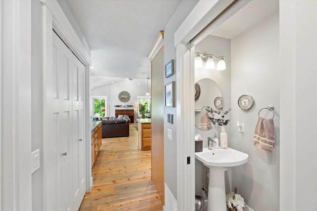 34777 Compass Ln, Polson, MT 59860 - hall with light wood-style floors, lofted ceiling, and baseboards