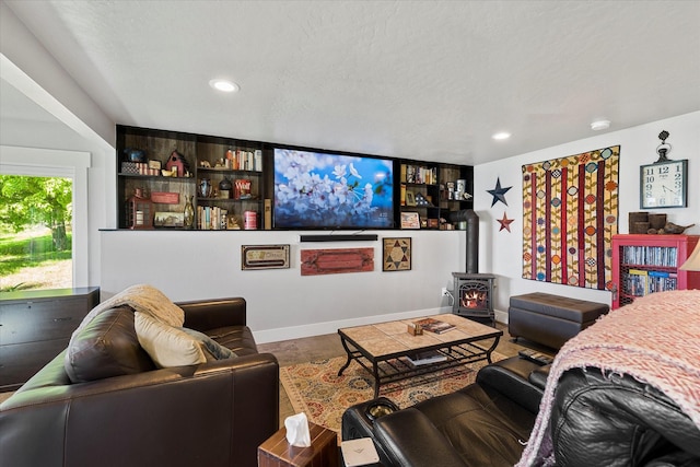 34777 Compass Ln, Polson, MT 59860 - living room featuring a wood stove, recessed lighting, and baseboards