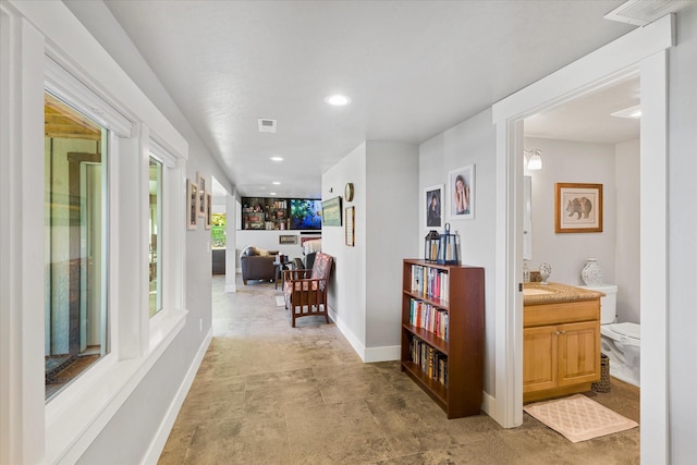 34777 Compass Ln, Polson, MT 59860 - hall featuring baseboards, recessed lighting, and a sink