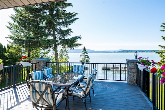 34777 Compass Ln, Polson, MT 59860 - wooden deck featuring a water and mountain view and outdoor dining space