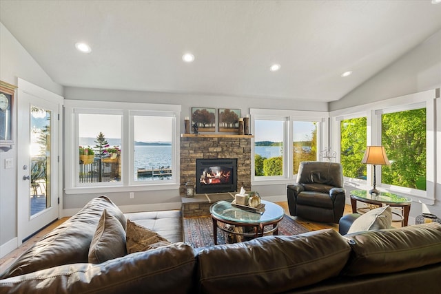 34777 Compass Ln, Polson, MT 59860 - living room featuring vaulted ceiling, recessed lighting, a stone fireplace, wood finished floors, and baseboards