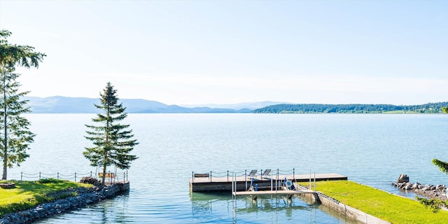 34777 Compass Ln, Polson, MT 59860 - water view with a boat dock and a mountainous background
