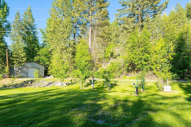 34777 Compass Ln, Polson, MT 59860 - view of green lawn featuring a garage and an outdoor structure