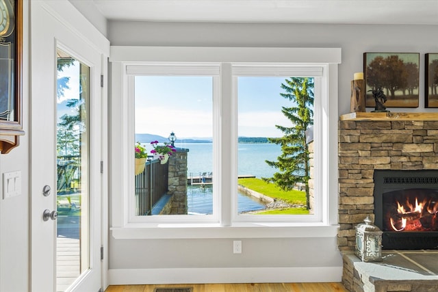34777 Compass Ln, Polson, MT 59860 - detailed view of a nearby body of water, a fireplace, and wood finished floors