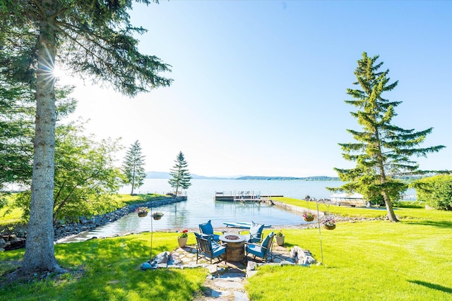 34777 Compass Ln, Polson, MT 59860 - view of grassy yard with a fire pit and a water view