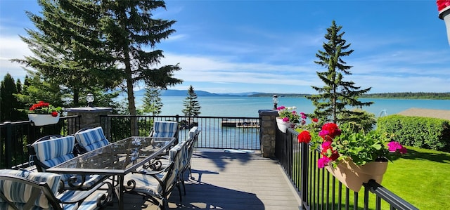 34777 Compass Ln, Polson, MT 59860 - wooden deck featuring a water and mountain view and outdoor dining space
