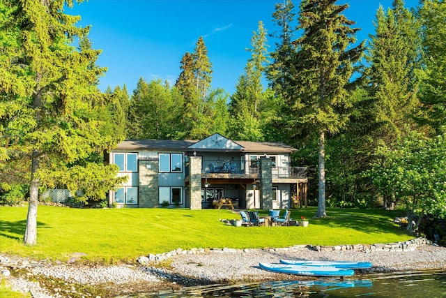 34777 Compass Ln, Polson, MT 59860 - back of house with a lawn, a fire pit, and a deck
