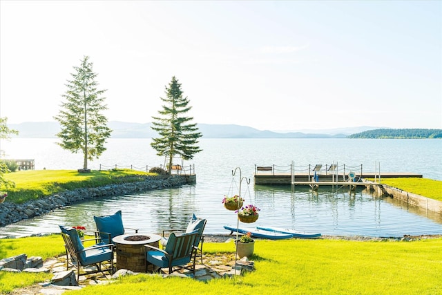 34777 Compass Ln, Polson, MT 59860 - dock area featuring a water and mountain view and a fire pit