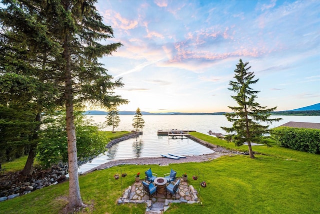 34777 Compass Ln, Polson, MT 59860 - dock area featuring a water view and a lawn
