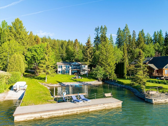 34777 Compass Ln, Polson, MT 59860 - dock area featuring a water view, a boat ramp, and a view of trees