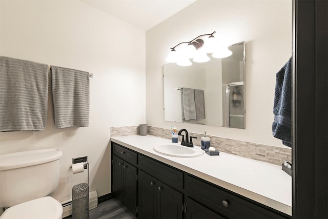 239 Essex St, Lolo, MT 59847 - full bathroom with vanity, baseboard heating, toilet, and an enclosed shower
