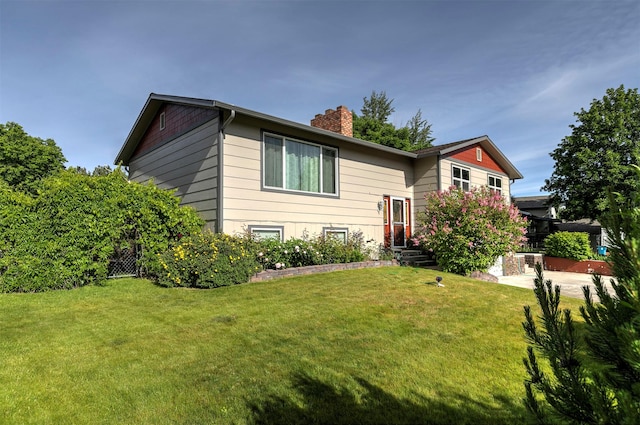239 Essex St, Lolo, MT 59847 - split foyer home with a chimney and a front lawn