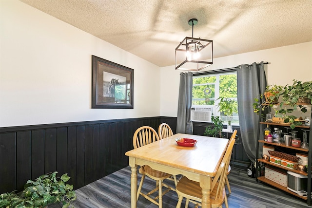 239 Essex St, Lolo, MT 59847 - dining area with a chandelier, a wainscoted wall, wood finished floors, a textured ceiling, and wood walls