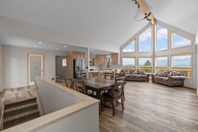 35280 Bennington Ln, Polson, MT 59860 - dining room with light wood-style flooring, beamed ceiling, high vaulted ceiling, baseboards, and recessed lighting