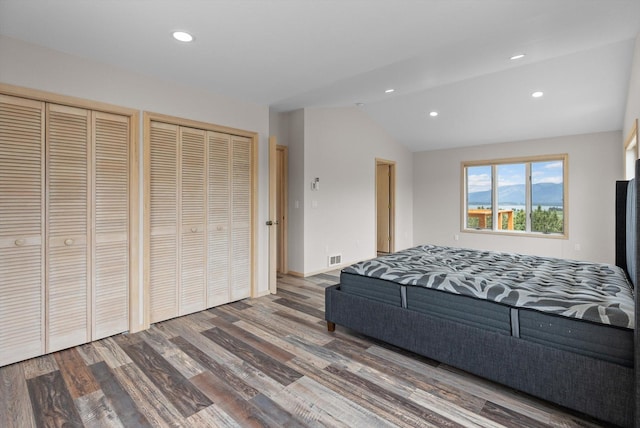 35280 Bennington Ln, Polson, MT 59860 - bedroom featuring lofted ceiling, multiple closets, wood finished floors, recessed lighting, and baseboards