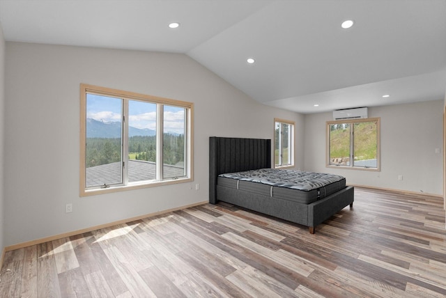 35280 Bennington Ln, Polson, MT 59860 - bedroom with an AC wall unit, wood finished floors, lofted ceiling, recessed lighting, and baseboards