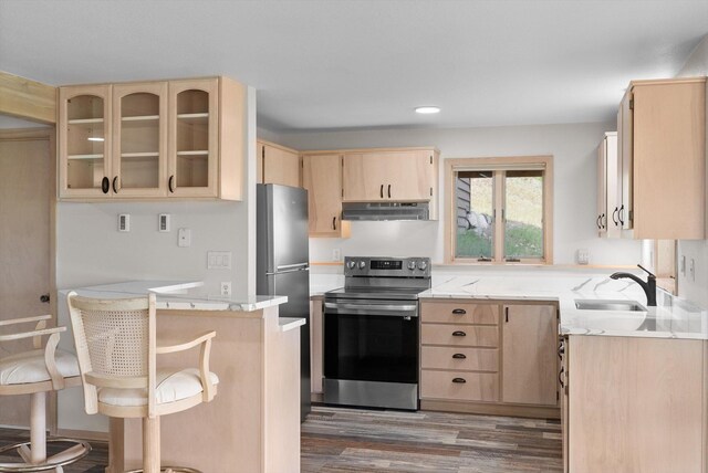 35280 Bennington Ln, Polson, MT 59860 - kitchen with stainless steel range with electric stovetop, light brown cabinets, a sink, under cabinet range hood, and recessed lighting