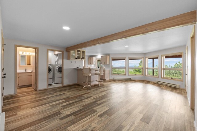 35280 Bennington Ln, Polson, MT 59860 - living area featuring washing machine and clothes dryer, a baseboard radiator, wood finished floors, and recessed lighting
