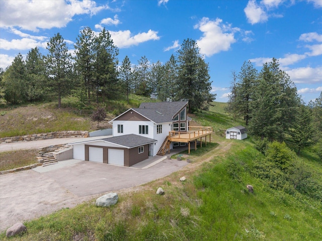 35280 Bennington Ln, Polson, MT 59860 - back of house featuring stairs, a wooden deck, asphalt driveway, and a garage