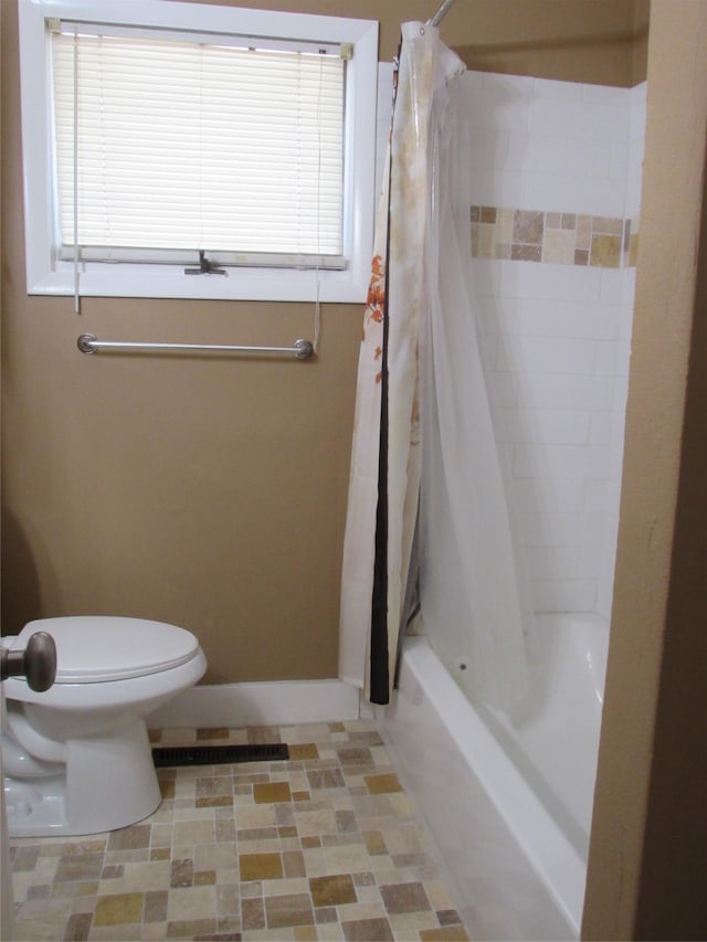 706 49th St S, Great Falls, MT 59405 - bathroom featuring toilet, shower / tub combo with curtain, and baseboards