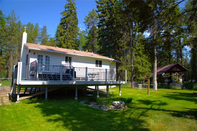 189 Dawn Dr, Columbia Falls, MT 59912 - back of property with a deck and a chimney