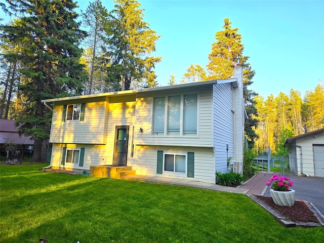 189 Dawn Dr, Columbia Falls, MT 59912 - rear view of property featuring a lawn and a chimney