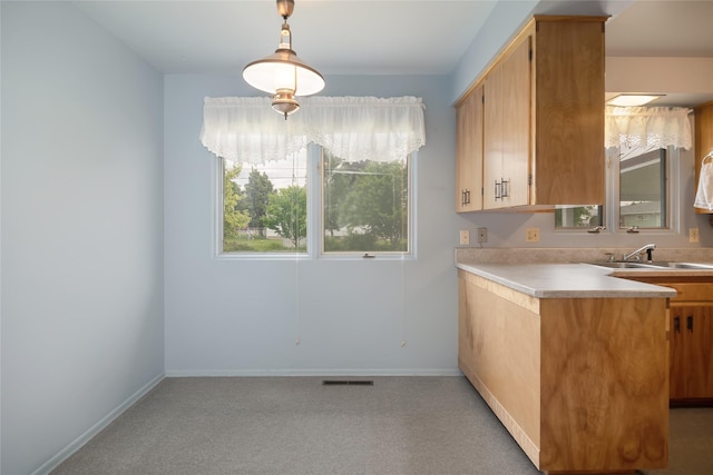 319 W Gail St, East Helena, MT 59635 - kitchen with a sink, baseboards, light countertops, and hanging light fixtures