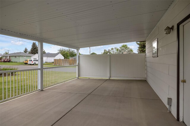 319 W Gail St, East Helena, MT 59635 - view of patio / terrace featuring an attached carport and a residential view
