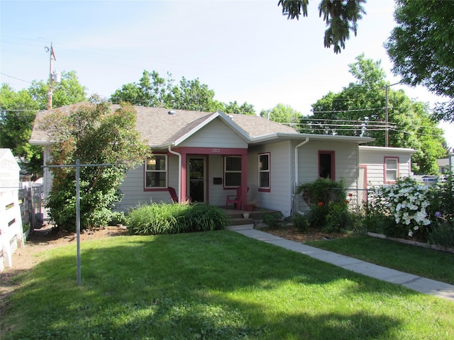 2323 3rd Ave S, Great Falls, MT 59405 - ranch-style home with covered porch, a front yard, and roof with shingles