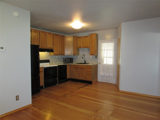 2323 3rd Ave S, Great Falls, MT 59405 - kitchen with electric range oven, a sink, under cabinet range hood, stainless steel microwave, and freestanding refrigerator