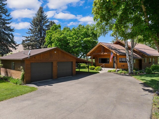 45 Panoramic Dr, Kalispell, MT 59901 - view of front of home with a garage, metal roof, and a front yard