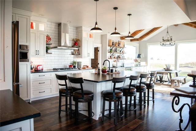 8138 Ranch Club Rd, Missoula, MT 59808 - kitchen with dark countertops, island exhaust hood, dark wood-style floors, vaulted ceiling, and recessed lighting